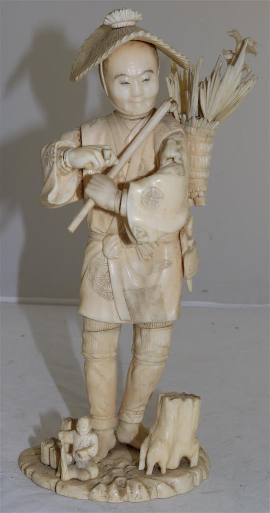 A Japanese sectional ivory figure of a flower seller, early 20th century, 26.5cm A/F